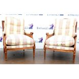 Pair of 20th century beech framed upholstered Bergere armchairs with caned seats and reeded legs.
