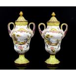 Pair of Continental pottery two handled vases and covers painted with lovers in landscape