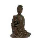 Asian brass figure of a woman seated with child, another wooden figure and two glass cylindrical
