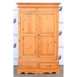 Modern pine double wardrobe with two doors above two drawers on plinth base. 197H x 123W x 53D.