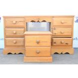 Modern pine kneehole desk with six short drawers together with a pine bed side table. 140W x 76H x