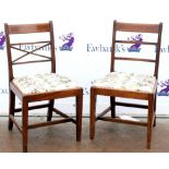 Two similar 20th century mahogany dining chairs with satinwood inlay on square tapering supports.