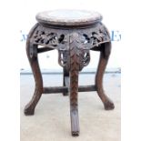 Chinese hardwood plant stand with marble top, having pierced floral carving on splayed legs joined