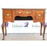 Walnut desk with three drawers on carved cabriole legs,