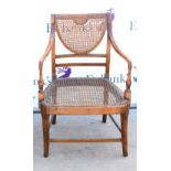 Early 20th century beech framed open armchair with caned back and seat,