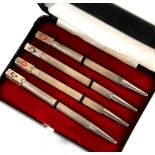 Cased set of four silver and enamel bridge pencils