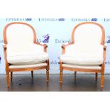 Pair of 20th century beech framed upholstered arm chairs on straight reeded legs.