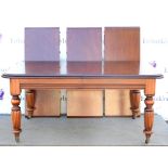 Reproduction mahogany extending dining table on turned and reeded legs on castors . 311 x 80H x