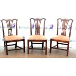 Set of three 19th century Chippendale style mahogany dining chairs on square tapering supports.