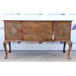 Late 19th century walnut breakfront sideboard with three drawers flanked by cupboards on carved