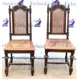 Pair of 19th century oak chairs, with floral carved top rails and caned seats, on turned legs joined