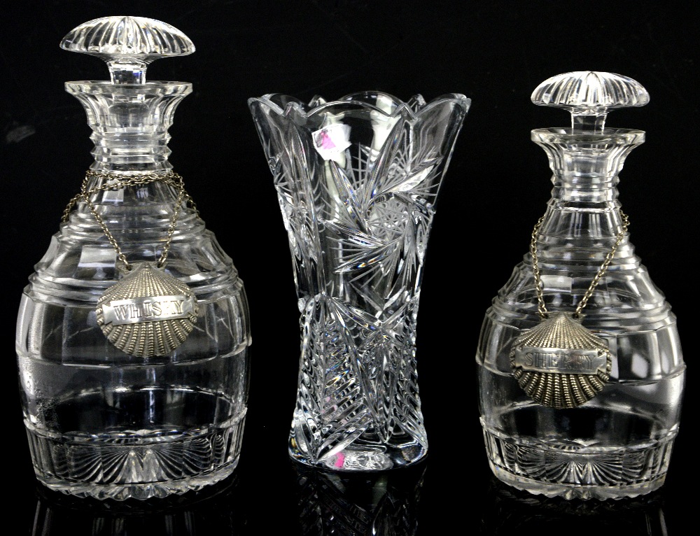 Two glass decanters with shell decanter labels and a glass vase