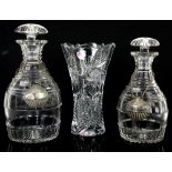 Two glass decanters with shell decanter labels and a glass vase