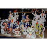 Collection of Staffordshire pottery figures and cottages to include a man on a rearing horse, 2
