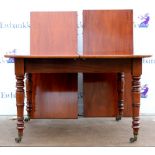 20th century mahogany dining table with two extra leaves on turned legs and castors. 240W x 75H x