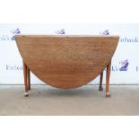 20th century oak drop-leaf table on pad feet. 72H x 160W x 117D