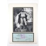 Batman - Adam West 1980 autographed cheque mounted underneath a black and white photo of Adam West