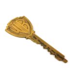 Warner Brothers - Oversized ‘Key to the Studios’ brass key, 10 inches long.