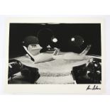 James Bond - Large black and white still showing the set of a a James Bond film, signed to the