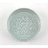 A Qingbai style monochrome saucer dish, decorated with bats; underglaze blue six-character mark of