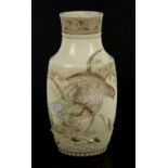 A Satsuma vase, decorated with a bird-of-prey in high relief, chasing a butterfly; 35 cm high; the