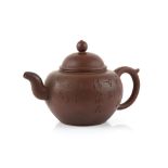 A Yi Xing teapot with loop handle and domed cover, decorated with an inscription on the exterior,