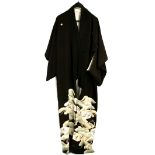 An aubergine/black kimono with a single sakura blossom either side of the eri; decorated across