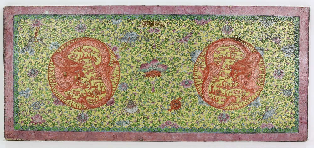 A famille rose plaque of rectangular form, decorated with coiled dragons on a yellow ground;