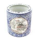 A blue decorated bitong of typical cylindrical form, decorated with panels in orange and en-