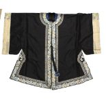 A Chinese textile, blue/black gown decorated with white ground floral rims; sleeve width about 50 cm