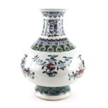 A large doucai style vase with trumpet neck, decorated with floral designs beneath a band of