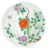 A large Chinese dish of circular form, decorated with a bold polychrome design of flowers and