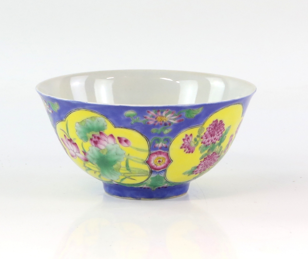 A famille rose bowl, decorated on a blue ground with panels of lotus, peony and prunus; the base - Image 2 of 4