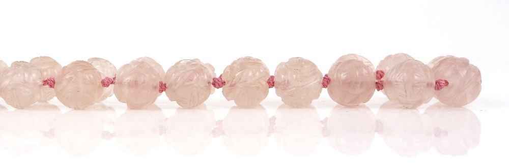 § A rose-quartz necklace with 35 beads, about 52 cm long; together with a white-metal mounted rose- - Image 4 of 8