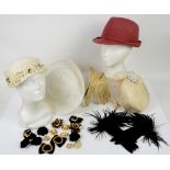 A collection of vintage hats including a white feather hat with floral applied band to border, a