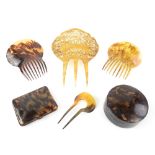 A group of hair combs, including one in tortoiseshell 16.5 x 12.2cm, one in horn and a larger