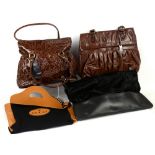 A collection of hand bags, to include a Gucci black and tan rayon and wool tote, Osprey black