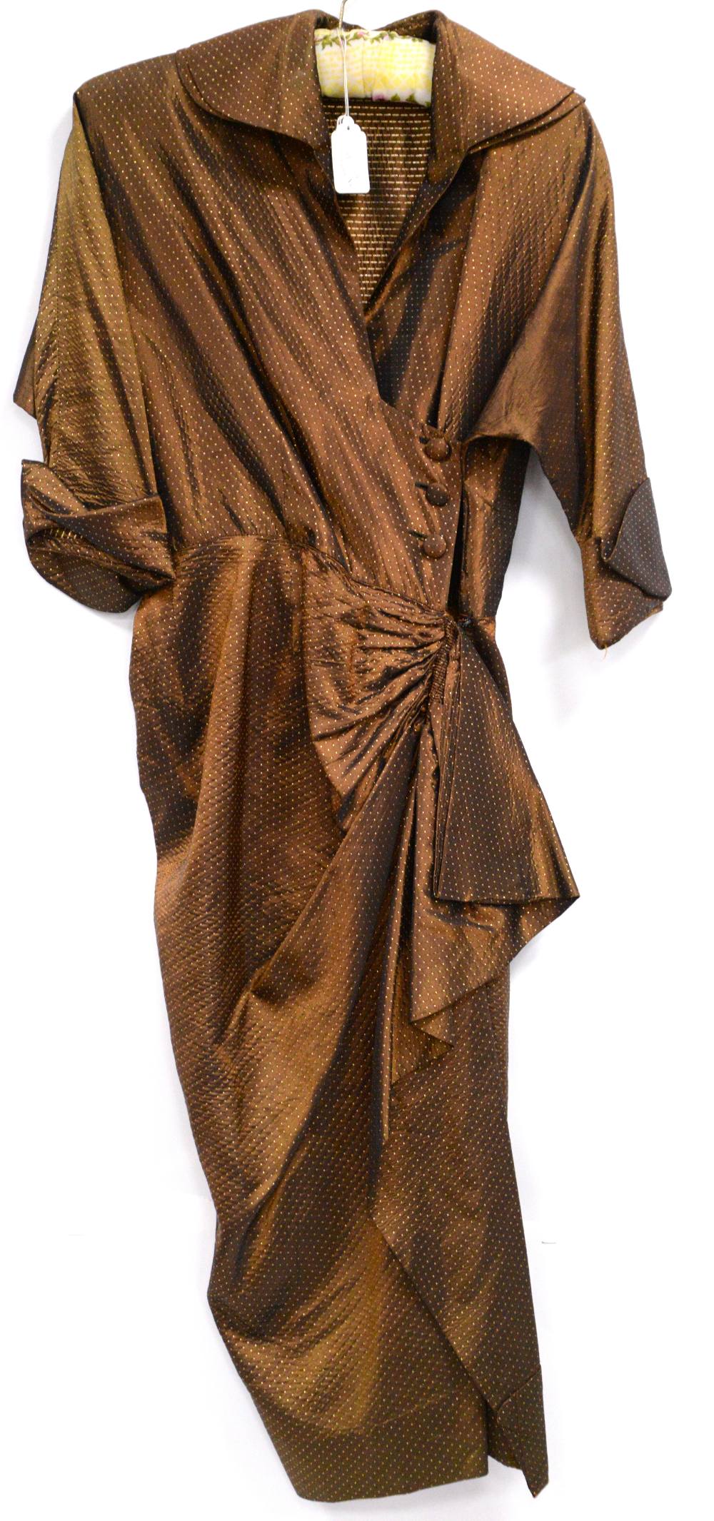 1940s bronze cocktail dress with raised spotted design and bat wing sleeve with bow design to