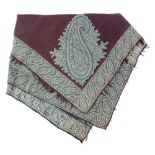 A 19th century Kashmiri Shawl central aubergine panel and deep woven stylised foliate border, re