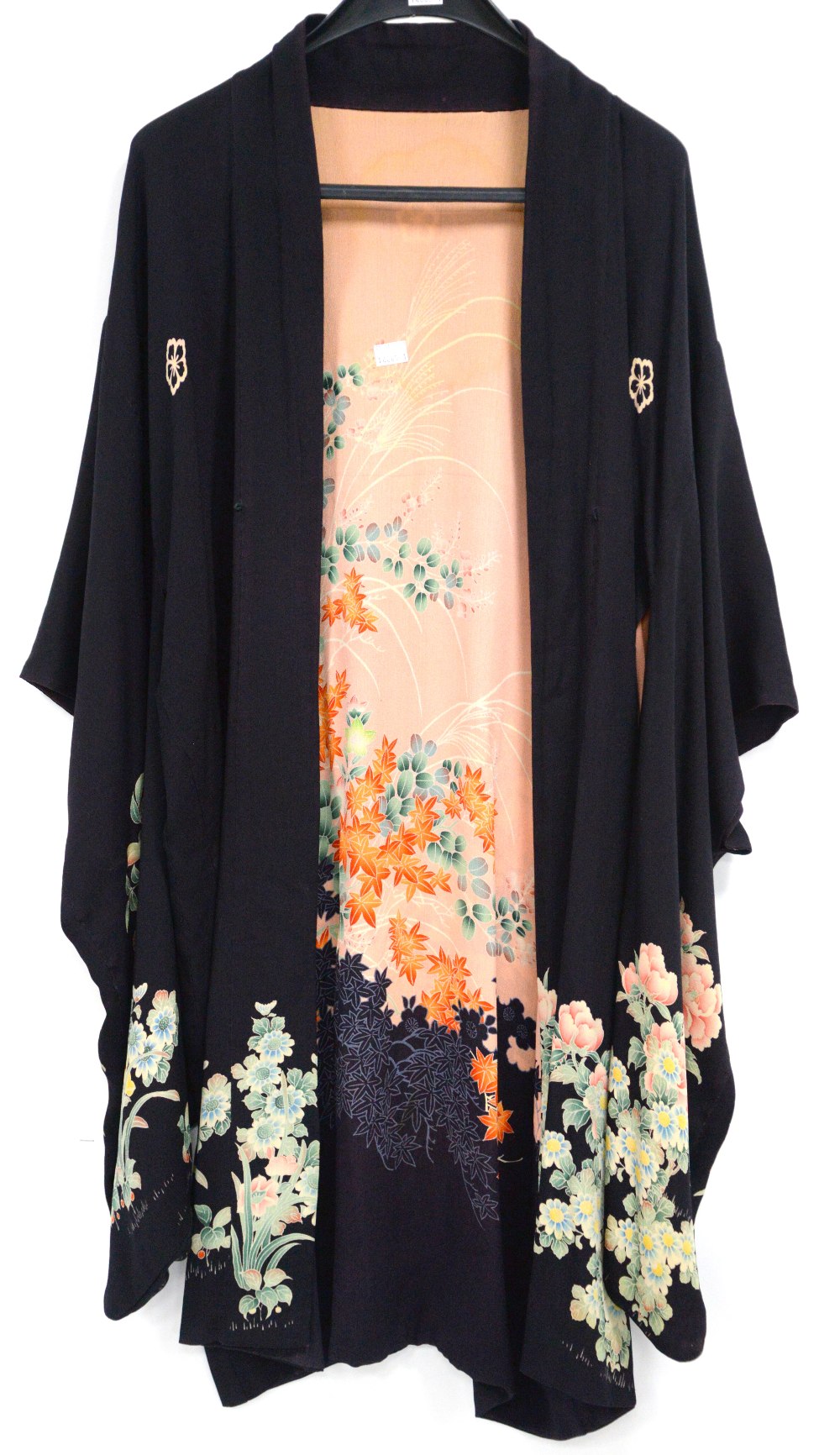 A 1920s Kimono style silk dressing gown with floral and foliate print on a black ground, peach