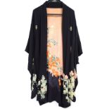 A 1920s Kimono style silk dressing gown with floral and foliate print on a black ground, peach