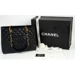 Chanel GST (“Grand Shopping Tote”) bag in black caviar leather with gold hardware, satin lined in