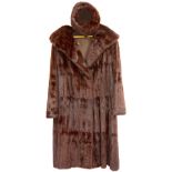 An Ermine brown dyed 3/4 length fur coat with shawl collar with silk lining and a similar fur hat in