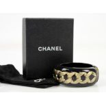 Chanel black resin cuff bangle with bold chain motif and typical crossed C’s with dustbag, box and