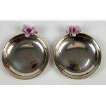 Pair of silver dishes each mounted with a ceramic flower