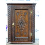 Oak wall hanging corner cupboard with carved decoration, 90 cm high