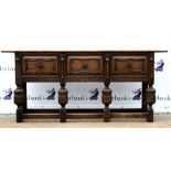 Late 19th century oak dresser base with three short geometric panelled drawers on turned supports