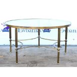 Modern brass circular glass topped coffee table on reeded legs and star shaped stretchers. 77