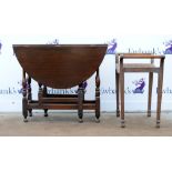 20th century oak gateleg table together with a caned stool. 111W x 72H x 91D