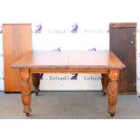 Late 19th century oak extending dining table with floral carved rim on turned and floral carved legs